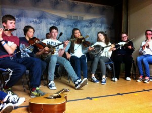 Members of Spink Comhaltas playing musical instruments together